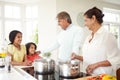 Grandparents And Grandchildren Cooking Meal At Home Royalty Free Stock Photo