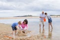 Grandparents and grandchildren playing at the beach Royalty Free Stock Photo