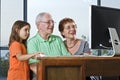 Grandparents and granddaughter with computer Royalty Free Stock Photo