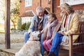 Grandparents With Granddaughter And Pet Dog Outside House Getting Ready To Go For Winter Walk Royalty Free Stock Photo