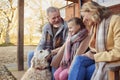 Grandparents With Granddaughter And Pet Dog Outside House Getting Ready To Go For Winter Walk Royalty Free Stock Photo