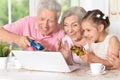 Grandparents with granddaughter playing computer game Royalty Free Stock Photo