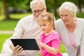 Grandparents and granddaughter with tablet pc Royalty Free Stock Photo