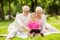 Grandparents and granddaughter with tablet pc Royalty Free Stock Photo