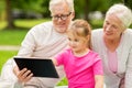 Grandparents and granddaughter with tablet pc Royalty Free Stock Photo