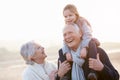 Grandparents And Granddaughter Walking On Winter Beach Royalty Free Stock Photo