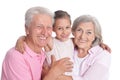 Grandparents with granddaughter on white