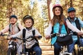 Grandparents and grandkids cycling on forest trail, close up Royalty Free Stock Photo