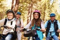 Grandparents and grandkids cycling on forest trail, close up Royalty Free Stock Photo