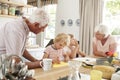 Grandparents and grandkids talking in the kitchen, close up Royalty Free Stock Photo