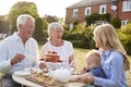 Grandparents Have Afternoon Tea With Grandson And Adult Daughter