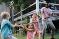 Grandparents have a tug of war with their granddaughters.