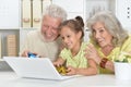 Grandparents with her granddaughter playing computer games with Royalty Free Stock Photo