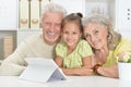 Grandparents with her granddaughter using tablet Royalty Free Stock Photo