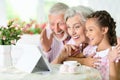 Grandparents with her granddaughter using tablet Royalty Free Stock Photo