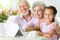 Grandparents with her granddaughter using tablet Royalty Free Stock Photo