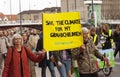 Grandparents holding a sign reading Save the Climate for my Grandchildren.