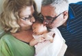 Grandparents Holding Sleeping Newborn Baby Granddaughter