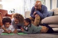 Grandparents At Home With Grandchildren Drawing Pictures In Lounge Together Royalty Free Stock Photo