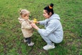 Grandparents in kids life, Grandparents teach children. Senior woman grandmother and little toddler girl playing outdoor Royalty Free Stock Photo