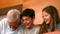 Grandparents laughing with their grandchildren