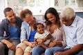 Grandparents, parents and a happy baby girl on mumÃ¯Â¿Â½s knee Royalty Free Stock Photo