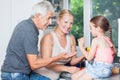 Grandparents play with little girl granddaughter