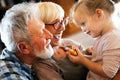 Grandparents playing and having fun with their granddaughter Royalty Free Stock Photo