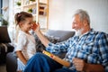 Grandparents playing and having fun with their granddaughter Royalty Free Stock Photo