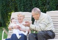 Grandparents playing with a little baby in the garden Royalty Free Stock Photo