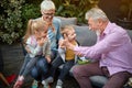 Grandparents playing with their grandchildren in the backyard