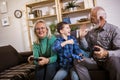 Grandparents playing video games with their grandson Royalty Free Stock Photo