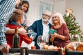 grandparents presenting christmas gifts to kids in beautiful Royalty Free Stock Photo