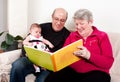 Grandparents reading book to baby girl Royalty Free Stock Photo