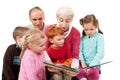 Grandparents reading kids story book to children