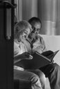 Grandparents reviewing their album of family photographs