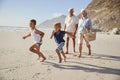 Grandparents Running Along Beach With Grandchildren Royalty Free Stock Photo