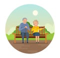 Grandparents are sitting on bench in park, smiling and speaking.