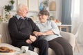 Grandparents sitting on couch Royalty Free Stock Photo