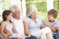 Grandparents Sitting Outisde with Grandchildren Royalty Free Stock Photo