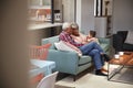 Grandparents Sitting On Sofa With Baby Granddaughter At Home Royalty Free Stock Photo