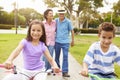 Grandparents Taking Grandchildren To Ride Bikes In Park Royalty Free Stock Photo