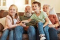 Grandparents, tv and children in a home living room streaming a web series together. Senior people, kids and television Royalty Free Stock Photo