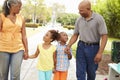 Grandparents Walking Grandchildren In Park Royalty Free Stock Photo