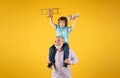 Grandson child and grandfather with toy plane and wooden toy truck. Men generation granddad and grandchild. Elderly old