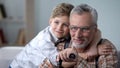 Grandson cuddling grandfather with love, precious family minutes, elderly care