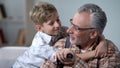 Grandson embracing grandfather with love, precious family minutes, elderly care