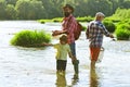 Grandson with father and grandfather fishing by lake. Coming together. Royalty Free Stock Photo