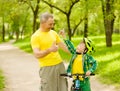 Grandson and grandfather having fun riding a bike Royalty Free Stock Photo
