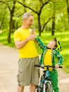 Grandson and grandfather having fun riding a bike Royalty Free Stock Photo